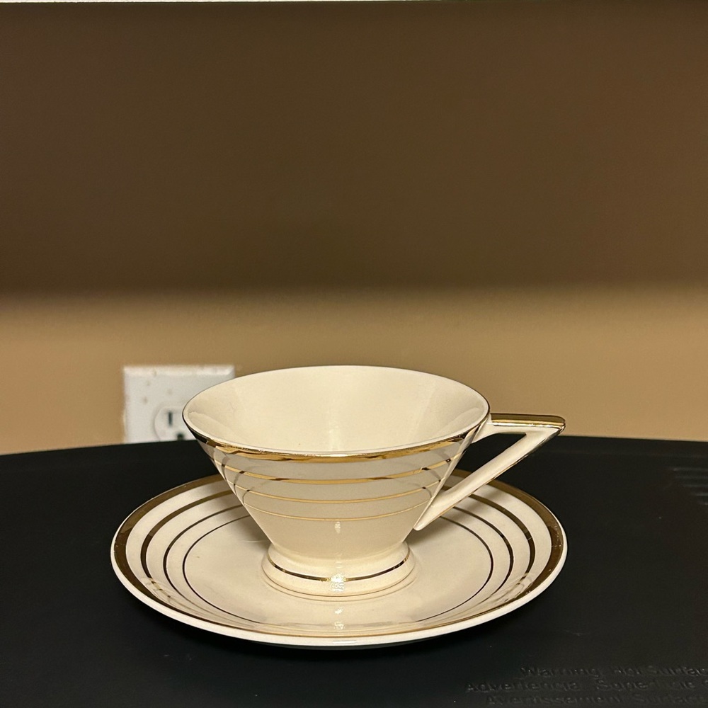 Elegant Cream and Gold Teacup with Saucer